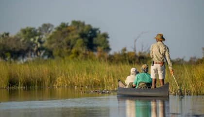 Traditional Canoeing Across Flooded Plains